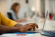 © PhotoAlto - Close-up of African American man's hands using laptop at office