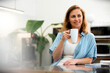 © PhotoAlto - Female entrepreneur having a coffee break at office