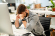 © PhotoAlto - Stressed male entrepreneur sitting at desk while having a headache