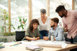 © PhotoAlto - Young adult businesswoman presenting work to coworkers