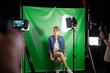 © PhotoAlto - Mid adult woman giving an interview while sitting against green screen