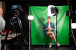 © PhotoAlto - Mid adult woman giving an interview while sitting against green screen