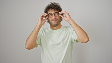 Poster - Young hispanic man smiling confident wearing glasses over isolated white background