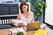 © Krakenimages.com - Middle age woman business worker using laptop reading document at office