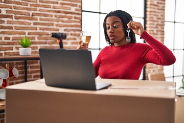 Wall Mural - Young african american with braids showing keys of new home doing video call making fish face with mouth and squinting eyes, crazy and comical.