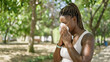 © Krakenimages.com - African american woman using tissue with pollen allergy at park