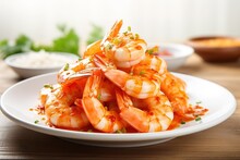 A Plate Of Shrimp With A Spicy Sauce