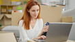© Krakenimages.com - Young redhead woman shopping with laptop and credit card sitting on floor at new home
