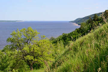 blue river with clear sky and green hills copy space 