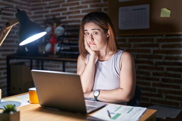 Wall Mural - Brunette woman working at the office at night thinking looking tired and bored with depression problems with crossed arms.