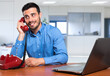 © Minerva Studio - Professional man talking on phone in office setting