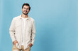 © SHOTPRIME STUDIO - Portrait of a stylish man smile with teeth in glasses for farsightedness and myopia, on a blue background in a white T-shirt, fashionable clothing style, space space