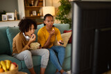 Fototapeta  - Mother and son watching scary movie on TV at home