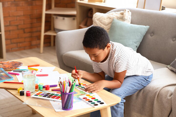 Canvas Print - Little African-American boy drawing at home