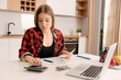 © Proxima Studio - Woman calculates the household budget