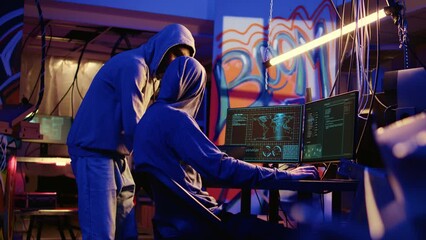Spies in secret hideaway doing valuable data theft by hacking governmental websites with weak security. Cybercriminals using extensive technology knowledge to access valuable information illegally