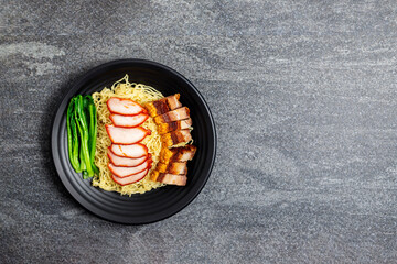 Poster - Pork noodles with pork, barbecue eggs, crispy pork, dumplings, green vegetables, healthy food, Thai, Chinese, Hong Kong, arranged on the table, top view. with Copy space for text