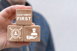 © wladimir1804 - Man holding wooden blocks with icon sees inscription: CUSTOMER FIRST. Client centricity business orientation. Customer first concept. VIP client servcie. Customer relationship management (CRM).
