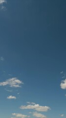 Wall Mural - Vertical time lapse of a white clouds and blue sky. No birds, no flicker