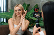 © InfiniteFlow - Two beautiful content creator making natural beauty and cosmetic tutorial on green plant leave garden video. Beauty blogger showing how to beauty care to social medial audience by selfie stick. Blithe