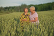 © yavdat - Two elderly women in a field, sharing a joke in the soft light of dusk. Symbolizes the importance of social interaction for mental health in aging.