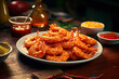 fried shrimp on a white plate with chili sauce