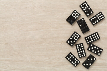 Wall Mural - Black domino tiles on wooden background, top view