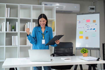 Business Asian woman are determined and excited about their work. Business success. Asian business women arms up after success job with customer