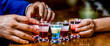 Man hands glasses of shot or liqueur. Glasses of alcohol. Tequila shots, vodka, whisky, rum. Group friends tequila shot glasses in bar
