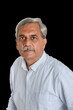 Senior Indian businessman or executive in a light blue shirt