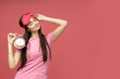 © Atlas - A young woman in a sleeping mask is holding an alarm clock