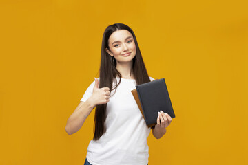 Wall Mural - Attractive young woman with books in hands