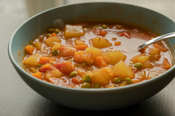 Wall Mural - Homemade vegetable soup close up view of vegan healthy soup in a bowl