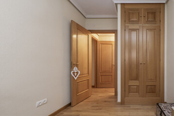 Wall Mural - Built-in wardrobe in the bedroom with oak wood doors, floors of the same material and carpentry of the house