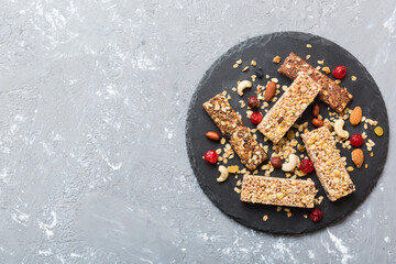 Wall Mural - Various granola bars on table background. Cereal granola bars. Superfood breakfast bars with oats, nuts and berries, close up. Superfood concept