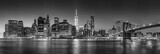 Fototapeta Londyn - Panoramic view of New York City Lower Manhattan skyscrapers at twilight with the Brooklyn Bridge and East River (Black and White)