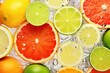 Slices of fresh juicy oranges, sweetie, lemons, grapefruits and limes in water. Citrus fruits cut pattern. Vibrant color summer design. Flat lay, top view
