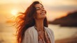 Portrait of calm happy smiling free woman with open arms and closed eyes enjoys a beautiful moment life on the seashore at sunset time