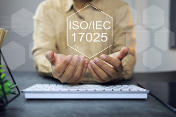 Wall Mural - ISO iec 17025 laboratory management standard concept with business person holdoing the iso icon on working desktop represent to applied to laboratory