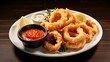 A plate of crispy calamari rings served with a side of marinara sauce.