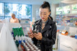 © Marko Geber - Young woman reading ingredients of skin care product while shopping at the drugstore