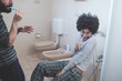 © Eugenio Marongiu - young multiethnic couple indoor bathroom brushing teeth