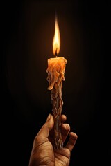 Poster - A person holding a lit candle in their hand. This image can be used to symbolize hope, peace, or spirituality. It can also be used in Halloween or horror-themed designs.