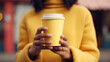 Yellow paper cup with coffee in woman hand. Time for drink coffee in city. Coffee to go. Enjoy moment, take a break. Disposable paper cup closeup. Delicious hot beverage. Mockup. Generated AI