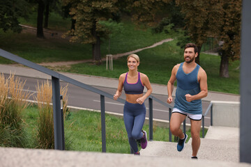 Sticker - Healthy lifestyle. Happy couple running up stairs outdoors