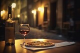 Fototapeta Fototapeta uliczki - Pizza, wine bottle, wineglasses and spice oil on the restaurant table outdoors, background of narrow old Italian streets 