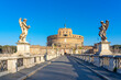 Dome of the Castel Sant Angelo in Rome, seen through a bridge adorned by statues over the Tiber river.
