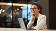 © Studio Nova - Young businesswoman sits pensively at her laptop in the background of the office.