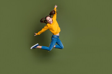 Canvas Print - Full length photo of overjoyed kid with ponytails hairdo dressed yellow shirt flying having fun yell isolated on khaki color background