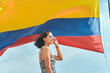 Smiling woman in front of Colombia flag